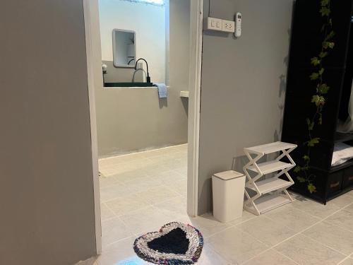 a heart shaped hat on the floor of a bathroom at Jungle Retreat Apartment in Chaloklum