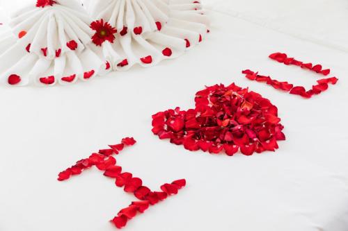 a group of red and white flowers on a table at AQua Hotel & Spa in Nha Trang
