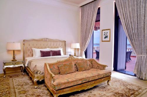 a large bedroom with a bed and a couch at Galle Face Hotel in Colombo