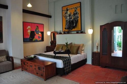 a bedroom with a bed and a table and a couch at 23 Love Lane Hotel in George Town