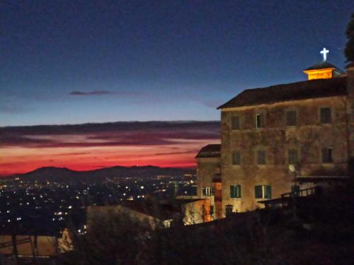 a building with a cross on top of it at night at B&B Francesca in Serrone