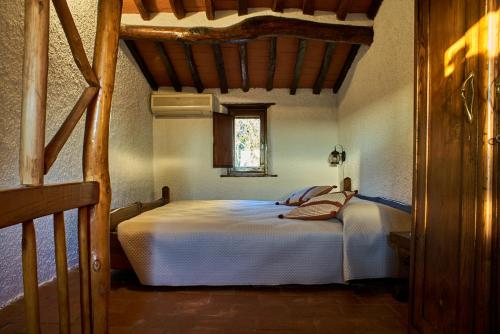 a bedroom with a large white bed with a window at Chez Paul in Massarosa