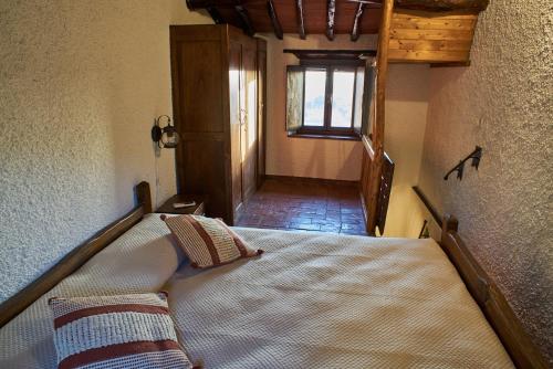 a bedroom with a bed in a room with a window at Chez Paul in Massarosa