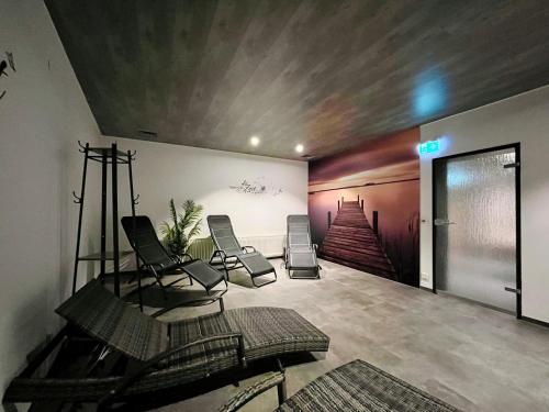 a room with two chairs and a painting on the wall at Hirschzauber A9 Montana Haus in Oberstdorf