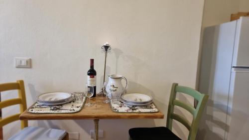a table with a bottle of wine and a wine glass at IL PICCINO 29, Esperienza Romantica in Borgo.... in Montescudaio