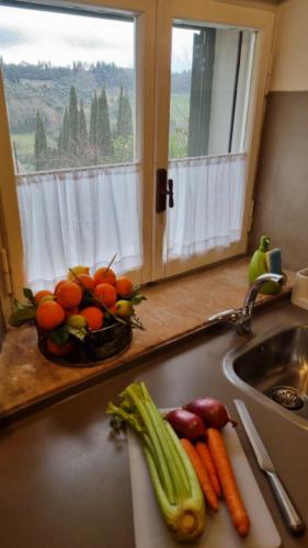 a sink with a bowl of fruit and vegetables on it at IL PICCINO 29, Esperienza Romantica in Borgo.... in Montescudaio