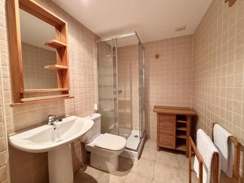 a bathroom with a sink and a toilet and a shower at BPirineos-Casa Chuanina in Benasque