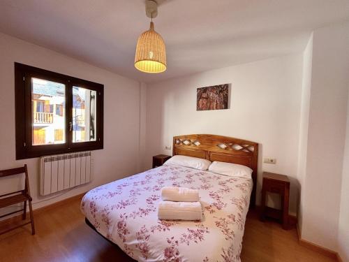 a bedroom with a bed with two towels on it at BPirineos-Casa Chuanina in Benasque