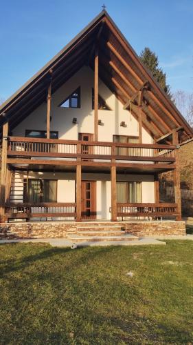 a large house with a large wooden roof at Casa Noastră in Vidra