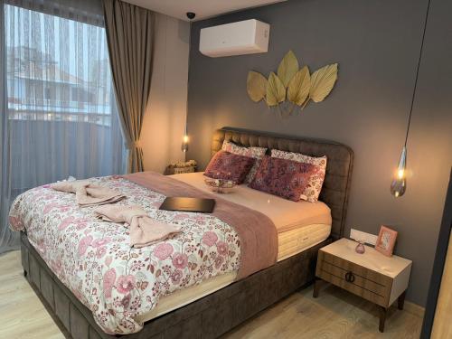 a bedroom with a large bed and a window at Lillium home in Plovdiv