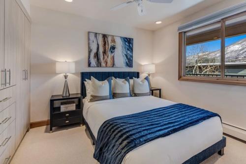 a bedroom with a bed and a window at New Listing 2BR 2BA Condo - Mountain Views in Aspen