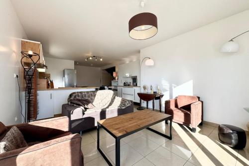 un salon avec un canapé et une table dans l'établissement Maison de vacances tout confort - 50m de la Ria, à Plouhinec