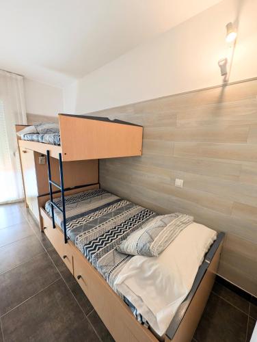 a bedroom with two bunk beds in a room at Apartament Marina in Tossa de Mar