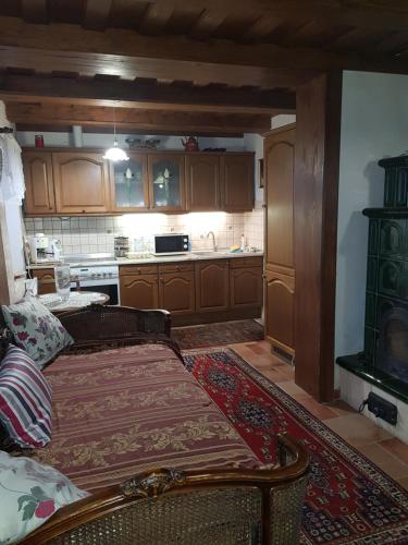 a kitchen with a couch and a stove at Klára apartman in Sárospatak
