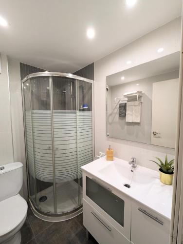 a bathroom with a shower and a toilet and a sink at Apartament Marina in Tossa de Mar