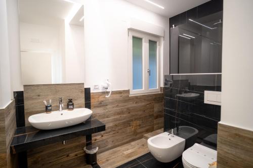 a bathroom with a sink and two toilets at DimorAmare in Bari