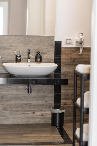 a bathroom sink on a counter with two stools at DimorAmare in Bari