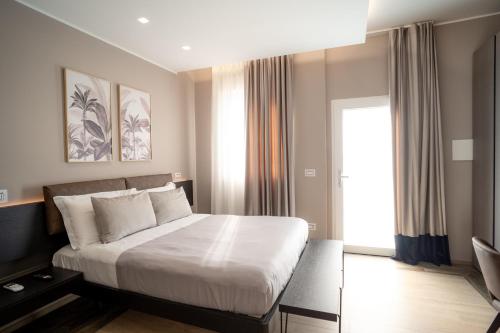 a bedroom with a large bed and a window at DimorAmare in Bari
