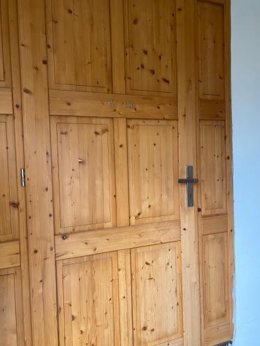 a wooden garage door with a cross on it at Zámecký Dvůr Černousy in V Poli