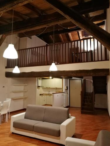 a living room with a couch and a loft at Palazzo Bargellini Panzacchi Apartments in Bologna
