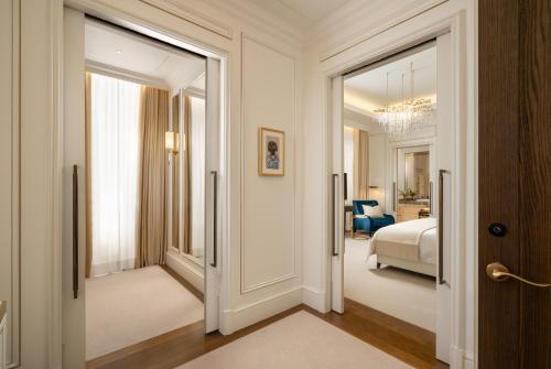 a hallway with a door leading to a bedroom at Corinthia Grand Hotel du Boulevard Bucharest in Bucharest