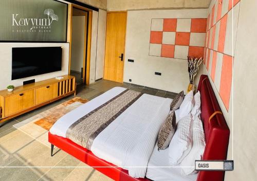 a bedroom with a large bed and a flat screen tv at Kavyum Retreat in Himatnagar