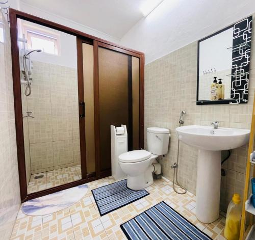 a bathroom with a toilet and a sink and a shower at 3 bedroom apartment in Pereybère in Pereybere