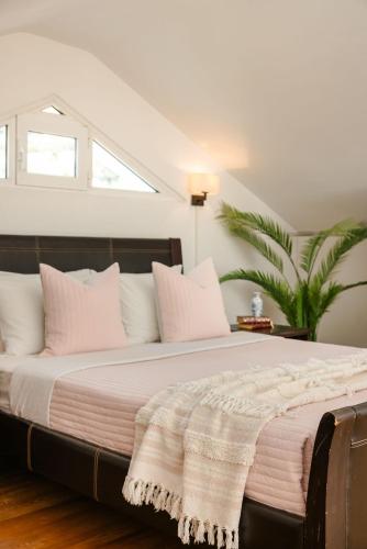 a bedroom with a large bed with white pillows at Pantheon Villa Svoronata in Svoronata