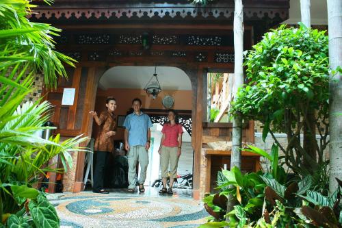 a group of people standing in the doorway of a building at Hotel 1001 Malam in Yogyakarta