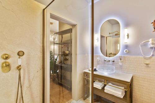 a bathroom with a shower and a sink and a mirror at Mestský Hotel Ďumbier in Brezno