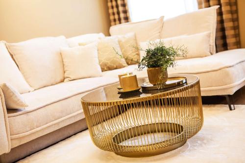 a living room with a couch and a coffee table at Mestský Hotel Ďumbier in Brezno