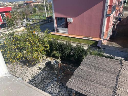 an overhead view of a garden with a bench in front of a building at B&B MareLuna in Angri