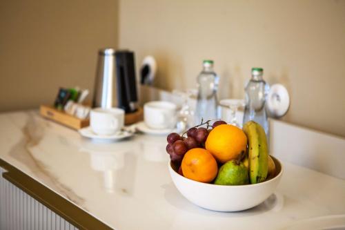 a bowl of fruit sitting on a counter at Mestský Hotel Ďumbier in Brezno
