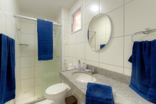 a bathroom with a sink and a toilet and a mirror at Breezes do cumbuco in Caucaia