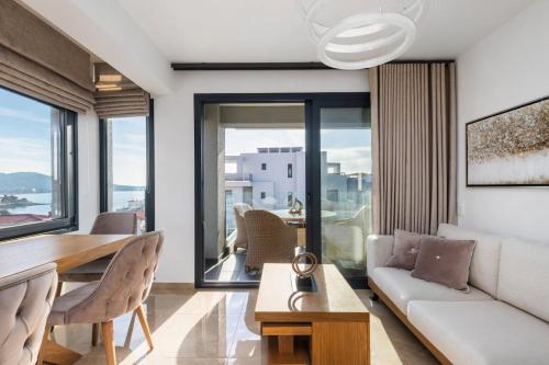 a living room with a couch and a table and chairs at Icon of the seas Sithonia in Neos Marmaras