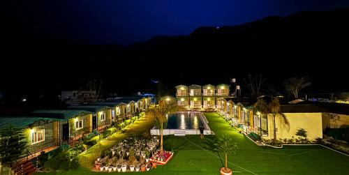 a town at night with a pool and buildings at Camp Brook - Luxury Camping in Rishikesh in Rishīkesh