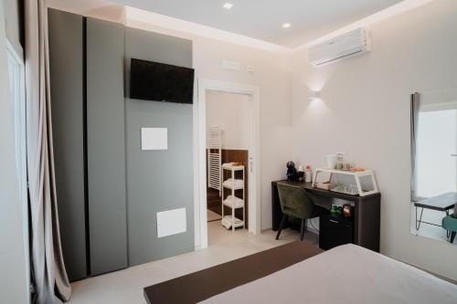 a bedroom with a bed and a desk with a computer at DimorAmare in Bari