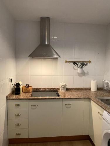 a kitchen with a sink and a stove at Casa Cabo Palos in Cabo de Palos