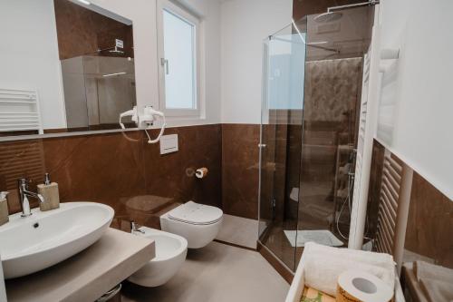 a bathroom with a sink and a toilet and a shower at DimorAmare in Bari