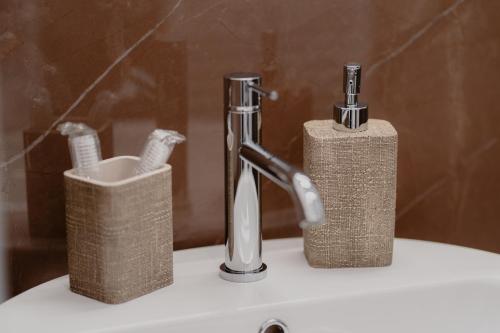 a bathroom sink with a faucet and a toothbrush holder at DimorAmare in Bari