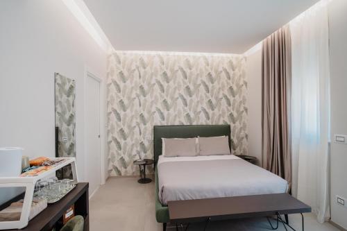 a small bedroom with a bed and a table at DimorAmare in Bari