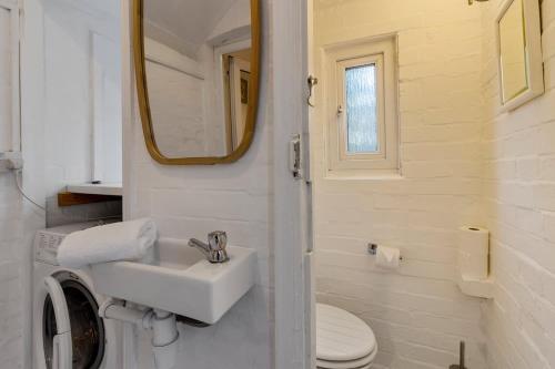 a bathroom with a sink and a toilet and a mirror at Exeter Station House - Short Stays UK Ltd in Exeter
