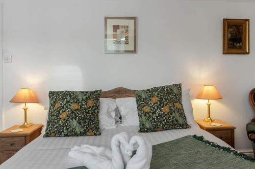 a bedroom with a bed with two towels on it at Exeter Station House - Short Stays UK Ltd in Exeter