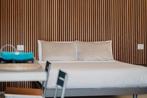 a bed with white sheets and pillows in a room at DimorAmare in Bari