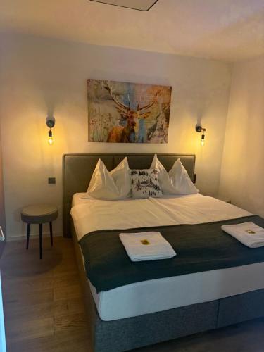 a hotel room with a bed with two towels on it at Chihuahua's Ötscher Apartment, but people are also very welcome in our eco-friendly resort! in Lackenhof