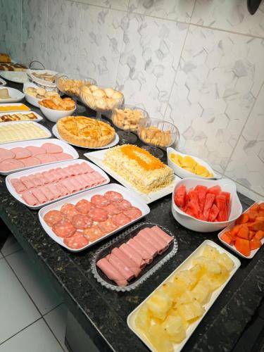 a buffet with many different types of meats and vegetables at Hotel Leda Rafael in João Câmara