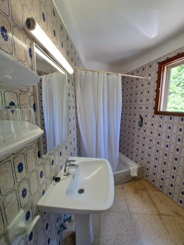 a bathroom with a sink and a shower at Hostal Playa in Cala Santanyi