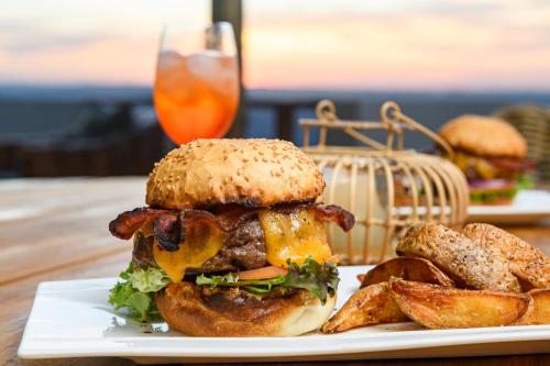 a sandwich and french fries on a white plate at Silverstreams Lodge, Villas & Cottages, Oribi Gorge in Glendale