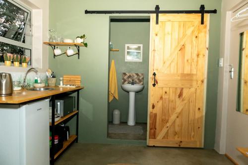 a bathroom with a toilet and a wooden door at Mia Amore in Caledon