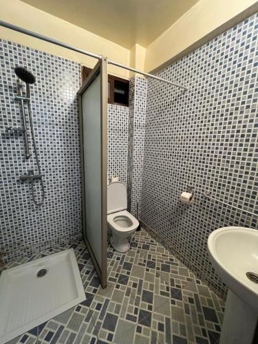 a bathroom with a toilet and a sink at Tasra Surf and Flow in Imsouane